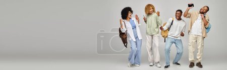 young cheering students in casual wear gesturing on gray background, studying concept, banner