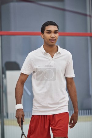 pierced african american sportsman playing squash inside of court, challenge and motivation
