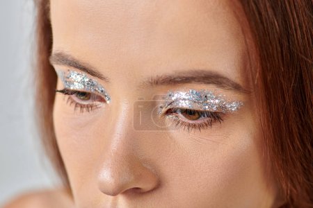 close up view of beautiful young woman with holiday makeup, shimmery eye shadow, Merry Christmas