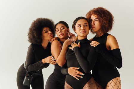 Photo for Appealing sexy african american women in black stylish bodysuits posing together, fashion concept - Royalty Free Image