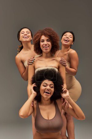 appealing happy african american women in comfy underwear having great time together, fashion