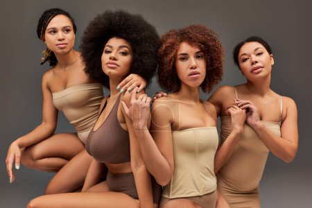 attractive young african american women in pastel underwear looking at camera, fashion concept