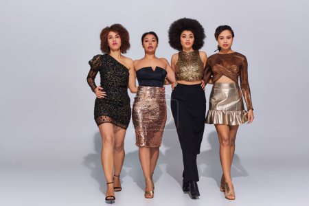 four attractive african american woman in party outfits spending time together, fashion concept