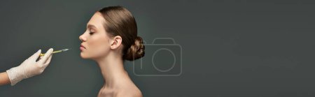 Photo for Esthetician in medical glove holding syringe near young woman on grey background, side view banner - Royalty Free Image