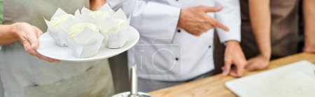cropped view of mature chef teaching how to bake his diverse students, cooking courses, banner