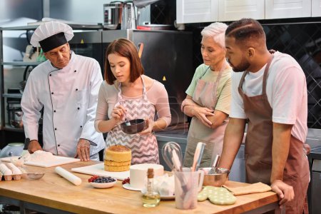 young attractive woman learning how to use silicone brush next to her diverse friends and chef
