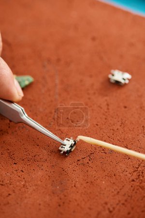Photo for Cropped view of skilled technician with tweezers working with microscheme in repair workshop - Royalty Free Image