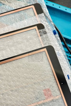 close up view of new touchscreens for smartphones in professional workshop, repair business