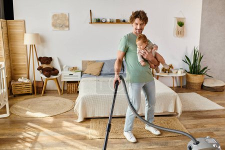 happy man multitasking housework and childcare, father vacuuming bedroom with infant son in arms