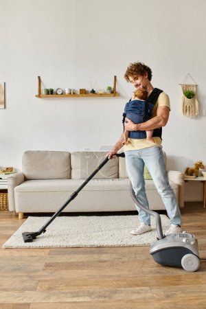 Photo for Happy man with infant baby boy in carrier vacuuming apartment at home, father and son bonding - Royalty Free Image