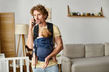 single father talking on smartphone with baby sleeping in carrier, balance between life and work