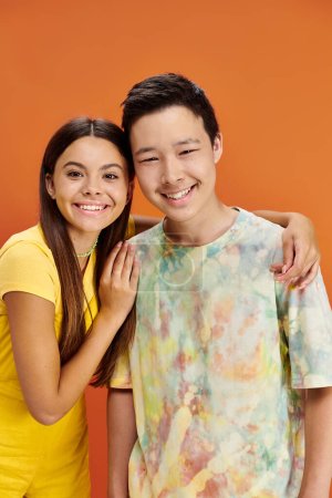 Photo for Joyful diverse teenagers in bring attires having fun and looking at camera, friendship day - Royalty Free Image