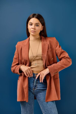 good looking adorable teenage girl in fashionable brown blazer posing and looking at camera