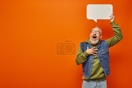 Photo for Surprised handsome mature man in stylish green hoodie posing with speech bubble above his head - Royalty Free Image