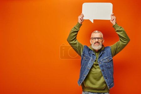 Photo for Attractive funky mature male model in green hoodie posing with speech bubble and looking at camera - Royalty Free Image