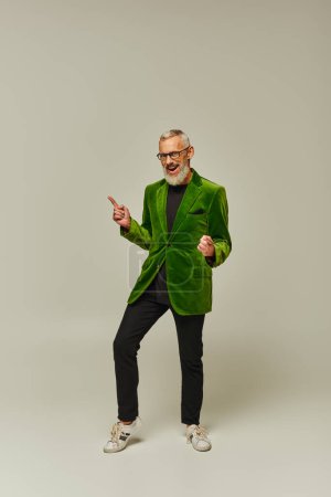 Photo for Joyful handsome mature male model in stylish outfit with beard and glasses smiling at camera - Royalty Free Image