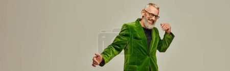 Photo for Joyful handsome mature man in vibrant attire with gray beard smiling happily at camera, banner - Royalty Free Image