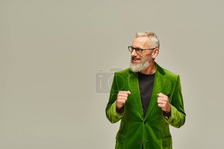 Photo for Handsome stylish mature jolly male model in vibrant fashionable attire smiling and looking away - Royalty Free Image