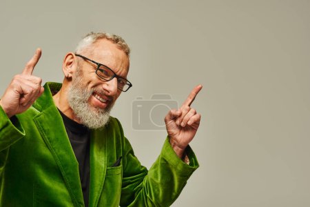 Photo for Joyous bearded mature male model in bright green blazer with accessories smiling at camera - Royalty Free Image