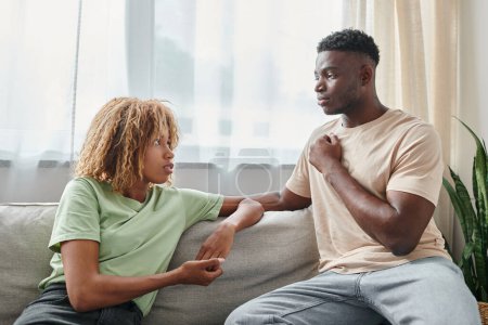 serious black man using sign language for communication with girlfriend in braces, quality time