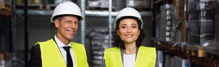 professional headshot banner, middle aged supervisor and female employee in hard hat with clipboard