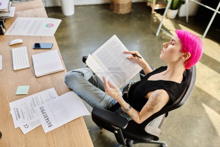 young pink haired woman sitting at desk with document with word bankruptcy on it, business concept