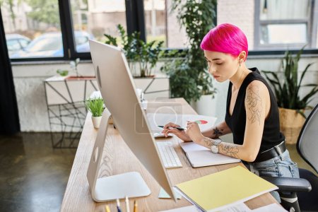 beautiful pensive businesswoman in urban casual outfit taking notes while working hard at computer