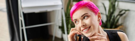 cheerful tattooed woman in casual urban outfit talking by phone at office, business concept, banner