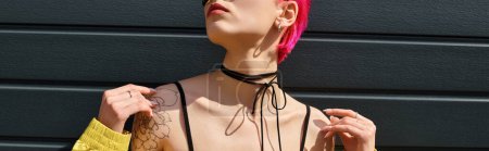 Photo for Pink haired young woman in yellow sunglasses and stylish outfit posing on urban street, banner - Royalty Free Image