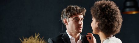 Photo for Handsome man looking at african american girlfriend during date on valentines day, banner - Royalty Free Image