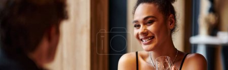 Photo for Banner of african american woman holding wine glass next to boyfriend during date on Valentines day - Royalty Free Image