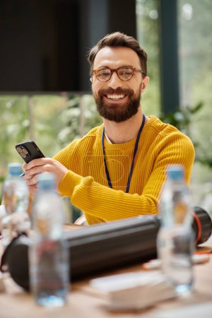 Photo for Cheerful handsome architect in yellow turtleneck working on his startup and looking at camera - Royalty Free Image