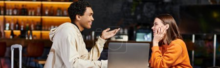 couple diversifié travaillant sur un projet ensemble, homme et femme noirs bavardant près d'un ordinateur portable, bannière