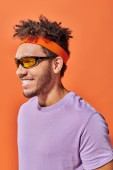 happy african american fella in eyeglasses looking away on orange background, optimistic man Longsleeve T-shirt #692583938