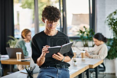 Curly-haired man with glasses taking notes in a dynamic office space, planning startup