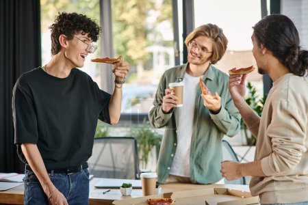 Photo for Smiling men enjoying a pizza lunch break in a friendly and relaxed office atmosphere, startup team - Royalty Free Image