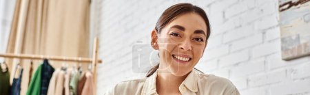 cheerful attractive woman in casual cozy homewear posing at home and looking at camera happily
