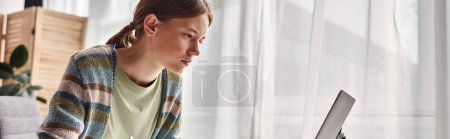 Photo for Horizontal banner of focused teenager doing homework at home, gen z girl looking at laptop - Royalty Free Image