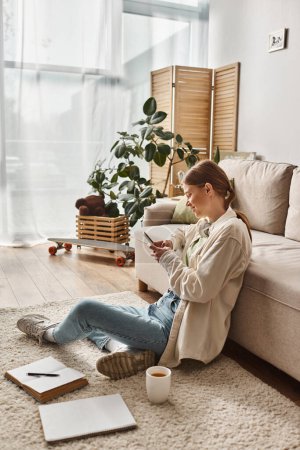teenage girl absorbed in social media on her smartphone at home, generation z lifestyle