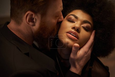 bearded man seducing african american woman with curly hair, intimate moment of sexy couple