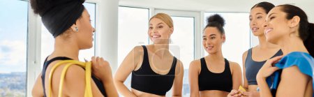 Photo for Group of happy diverse sportswomen holding resistance bands and chatting post workout, banner - Royalty Free Image