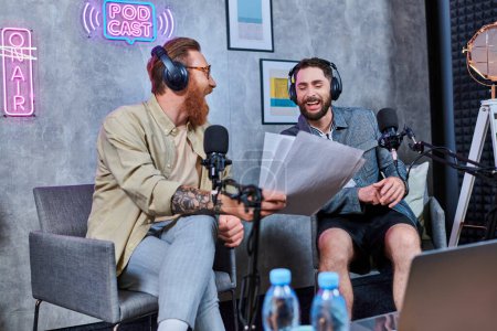 hard working red haired interviewer discussing main questions with his young guest during podcast