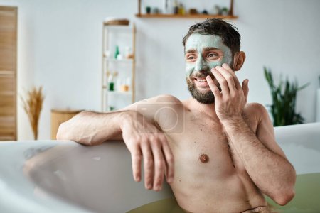 joyous handsome man with beard and face mask chilling in his bathtub, mental health awareness