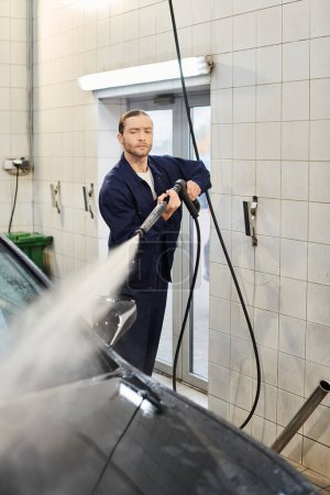 atractivo trabajador serviceman en uniforme cómodo con el coche recogido del lavado del pelo cuidadosamente