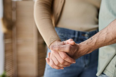 Photo for Cropped view closeup image of couple in love holding hands. Symbol sign sincere feelings, compassion - Royalty Free Image