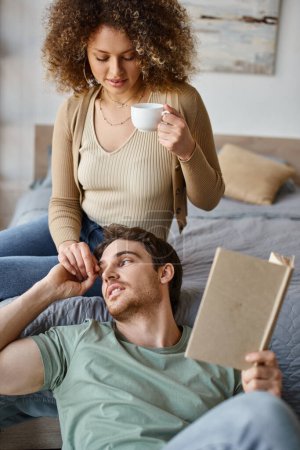 Casual conversation over morning coffee, curly young woman and brunette man enjoy time together