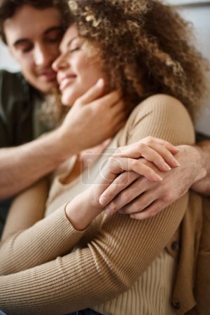 Closeup image of hands of curly young woman and brunette man sharing a heartfelt hug