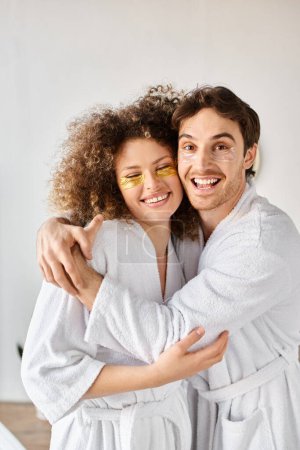 Portrait of couple with eye patches  hugging in bathroom and smiling, looking at camera