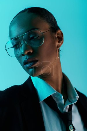 Young African American woman in a suit and tie, confidently wearing glasses