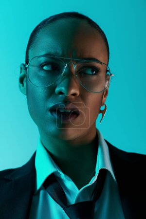 Young African American woman with glasses and a suit, exuding confidence and intelligence